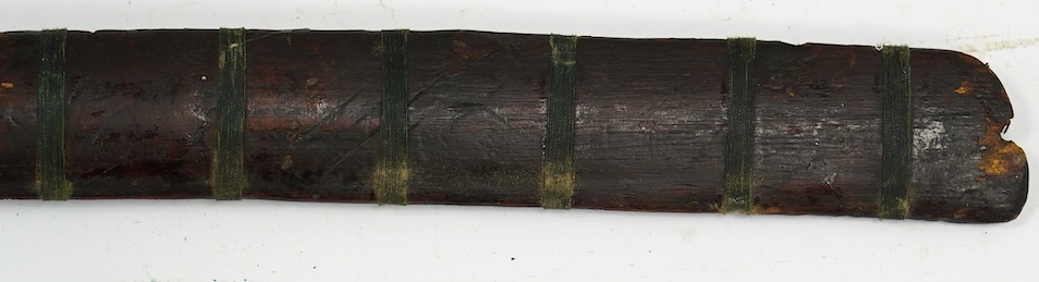 A Burmese sword Dha, curved single edge blade, hilt bound with platted rattan, in its wooden scabbard, blade 60cm. Condition - fair
